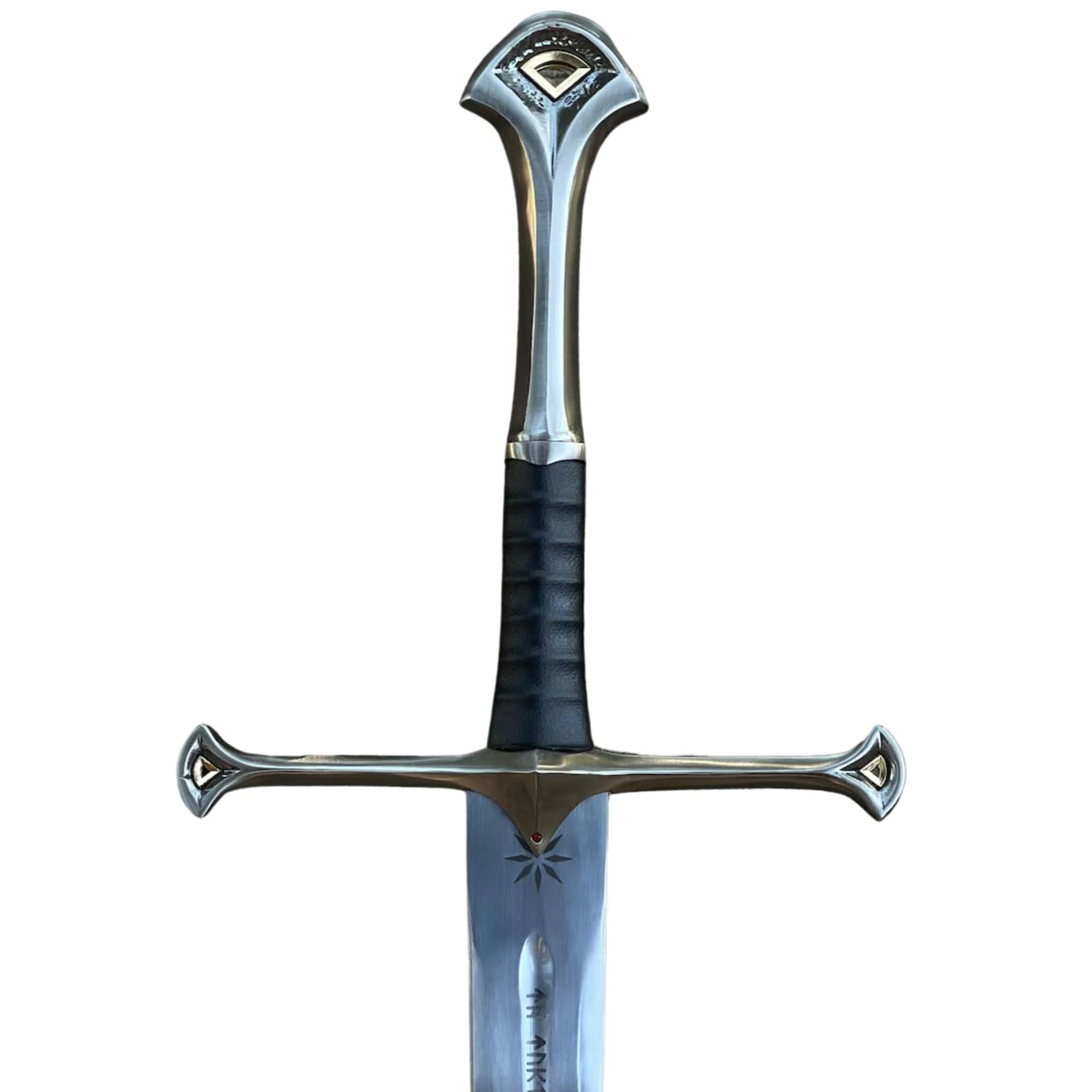 Close-up of polished metal Fantasy Sword blade and matching scabbard tip with elegant silver detailing.